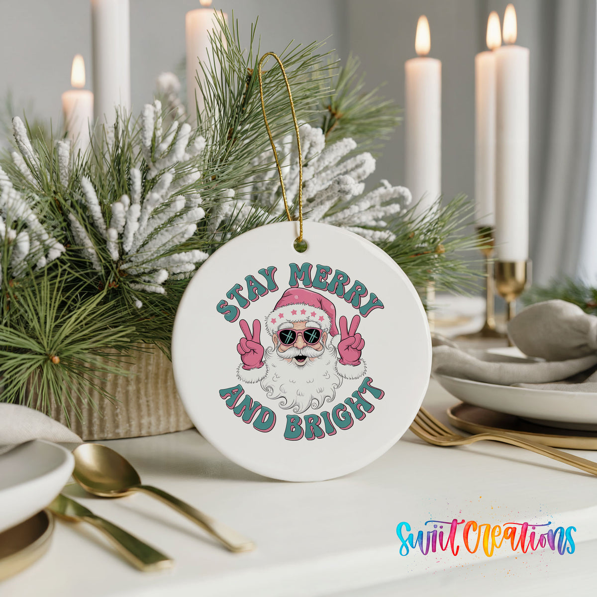 Round ceramic Christmas ornament featuring Santa in sunglasses giving peace signs with Stay Merry and Bright lettering, styled with elegant holiday table decor