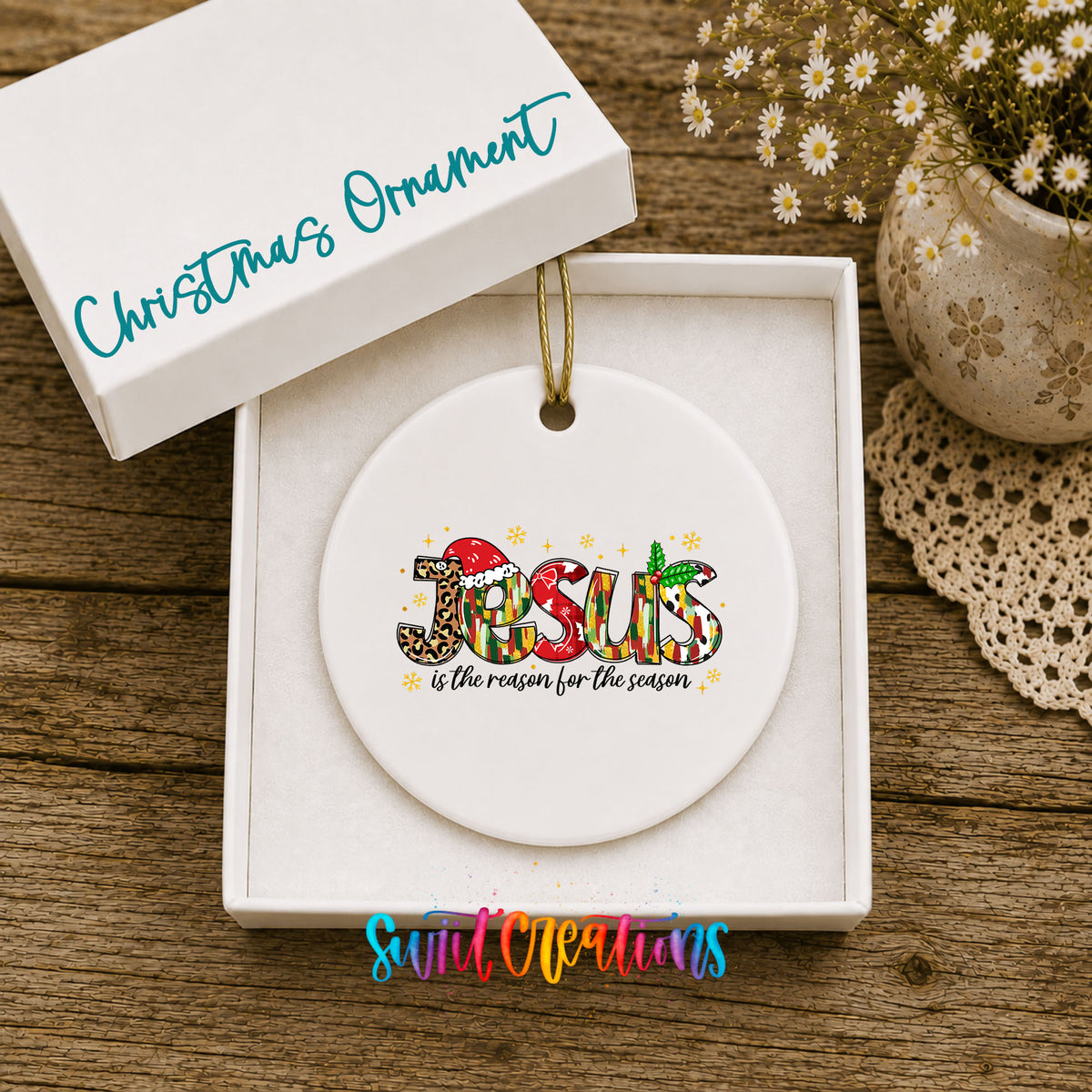 Round ceramic Christmas ornament featuring colorful Jesus Is the Reason for the Season typography, displayed in the included gift box