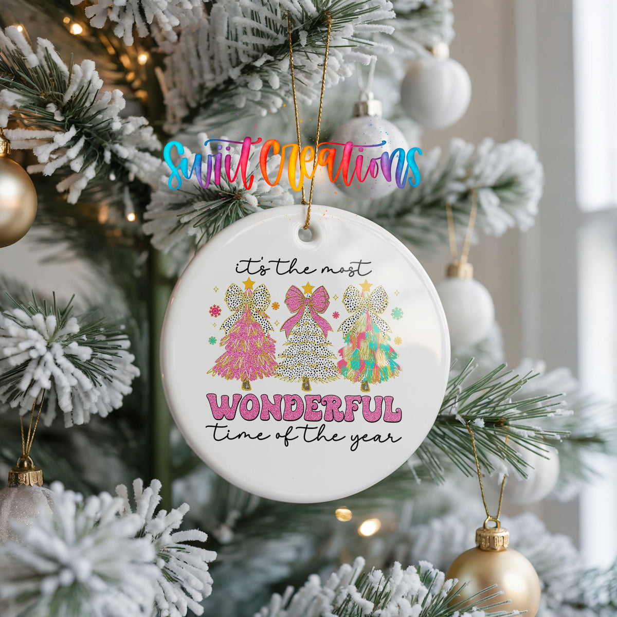 Round ceramic Christmas ornament featuring It’s the Most Wonderful Time of the Year lettering with colorful gifts and trees, hanging on a frosted Christmas tree