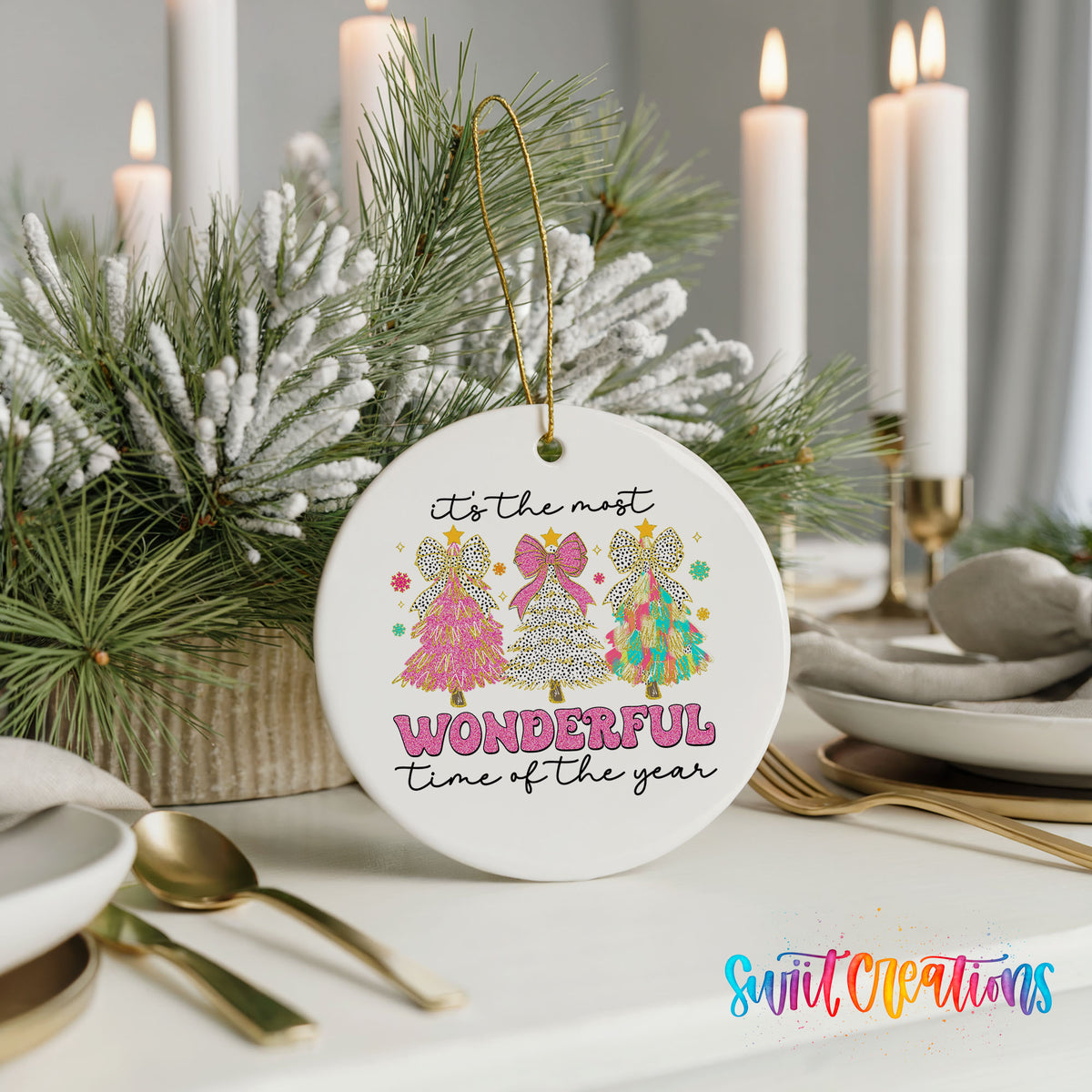 Round ceramic Christmas ornament featuring It’s the Most Wonderful Time of the Year lettering with colorful gifts and trees, styled with elegant holiday table decor