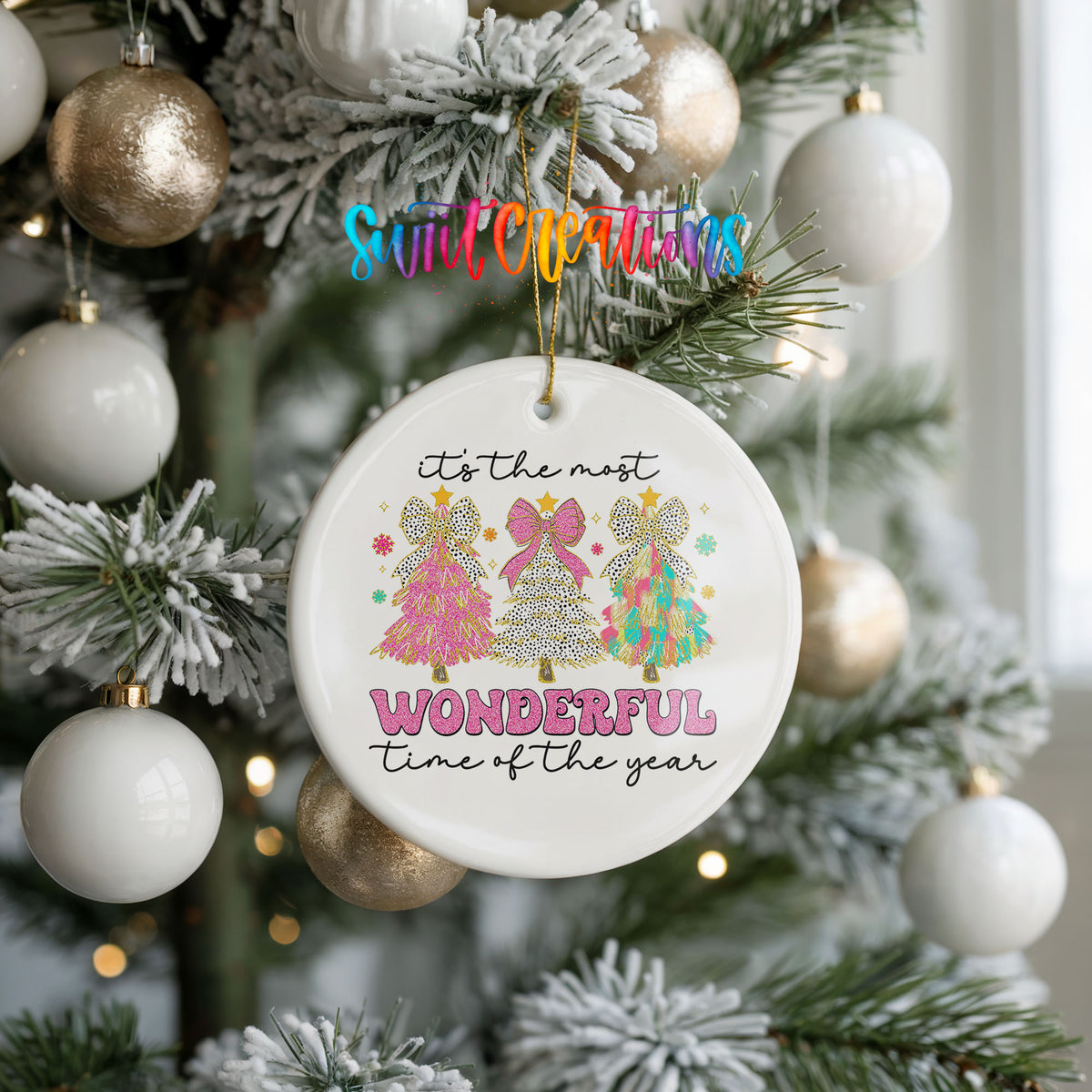 Round ceramic Christmas ornament featuring It’s the Most Wonderful Time of the Year lettering with colorful gifts and trees, hanging on a frosted holiday tree