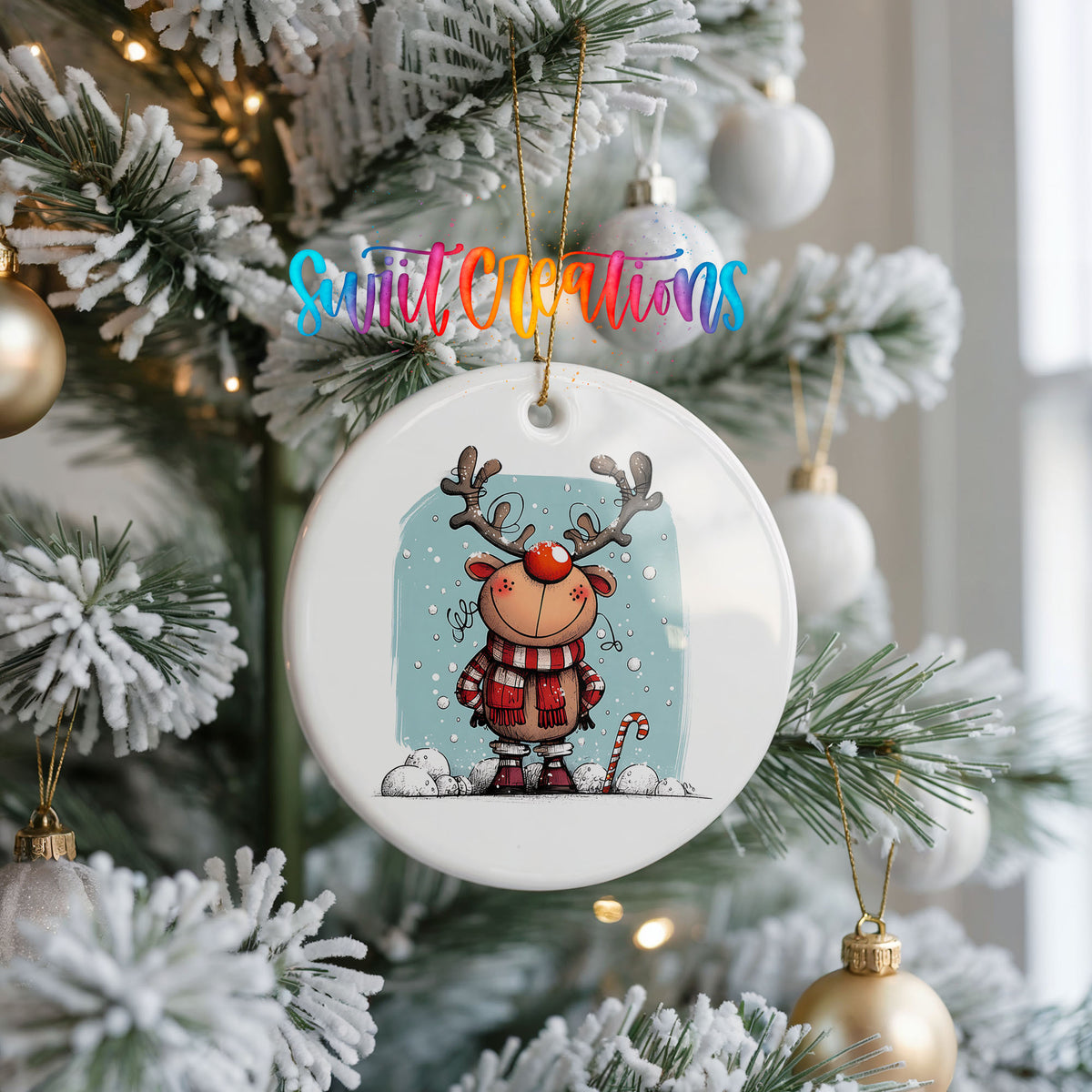 Round ceramic Christmas ornament featuring smiling reindeer in red plaid winter clothes against a snowy blue background, hanging on a frosted Christmas tree