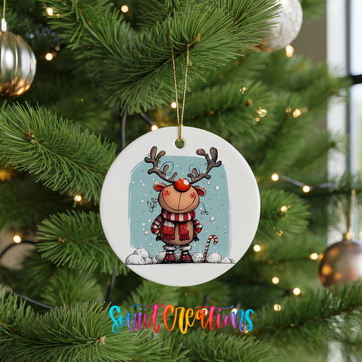 Round ceramic Christmas ornament featuring smiling reindeer in red plaid winter clothes against a snowy blue background, hanging on a green Christmas tree