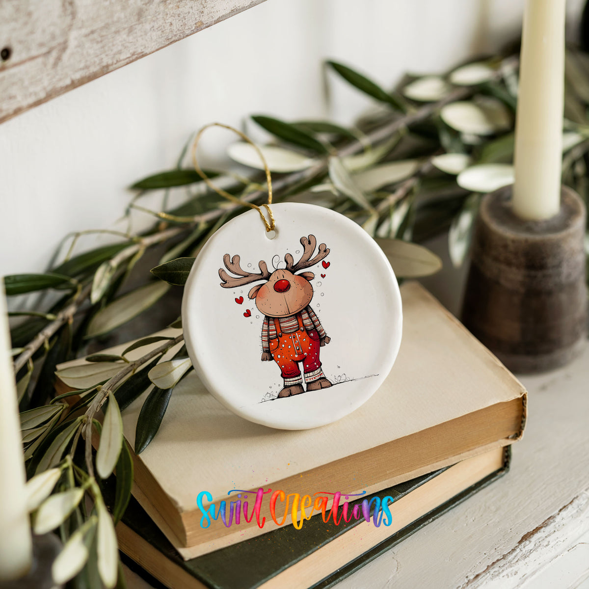 Reindeer in Red Plaid Shirt Christmas ornament styled on books with holiday greenery