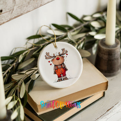 Reindeer in Red Plaid Shirt Christmas ornament styled on books with holiday greenery