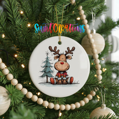 Sitting Reindeer with Pine Trees and Gift Christmas ornament hanging on a decorated Christmas tree