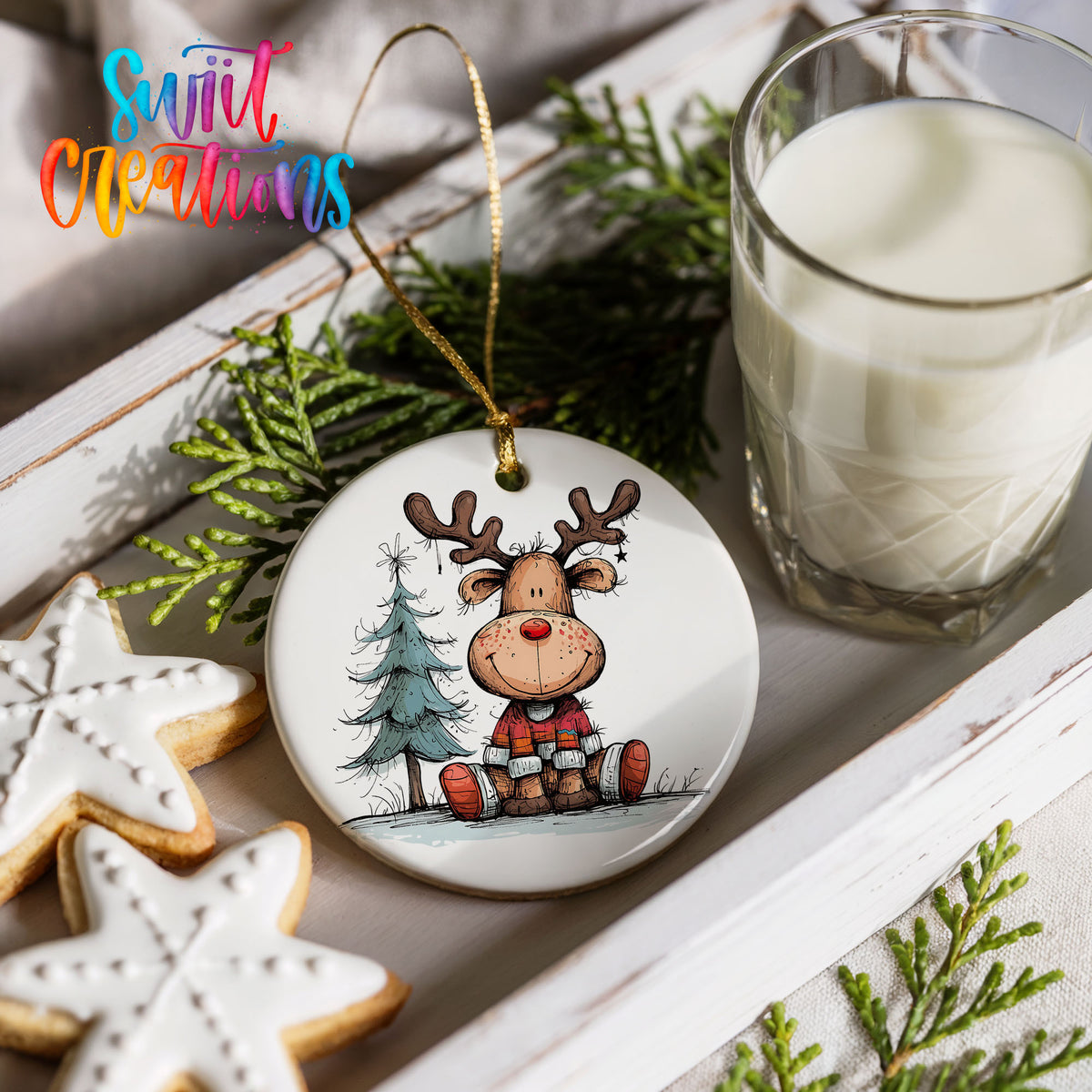 Sitting Reindeer with Pine Trees and Gift Christmas ornament styled with cookies and milk