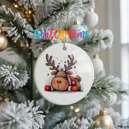 Cute Reindeer with Red Gift Bag Christmas ornament hanging on a frosted Christmas tree