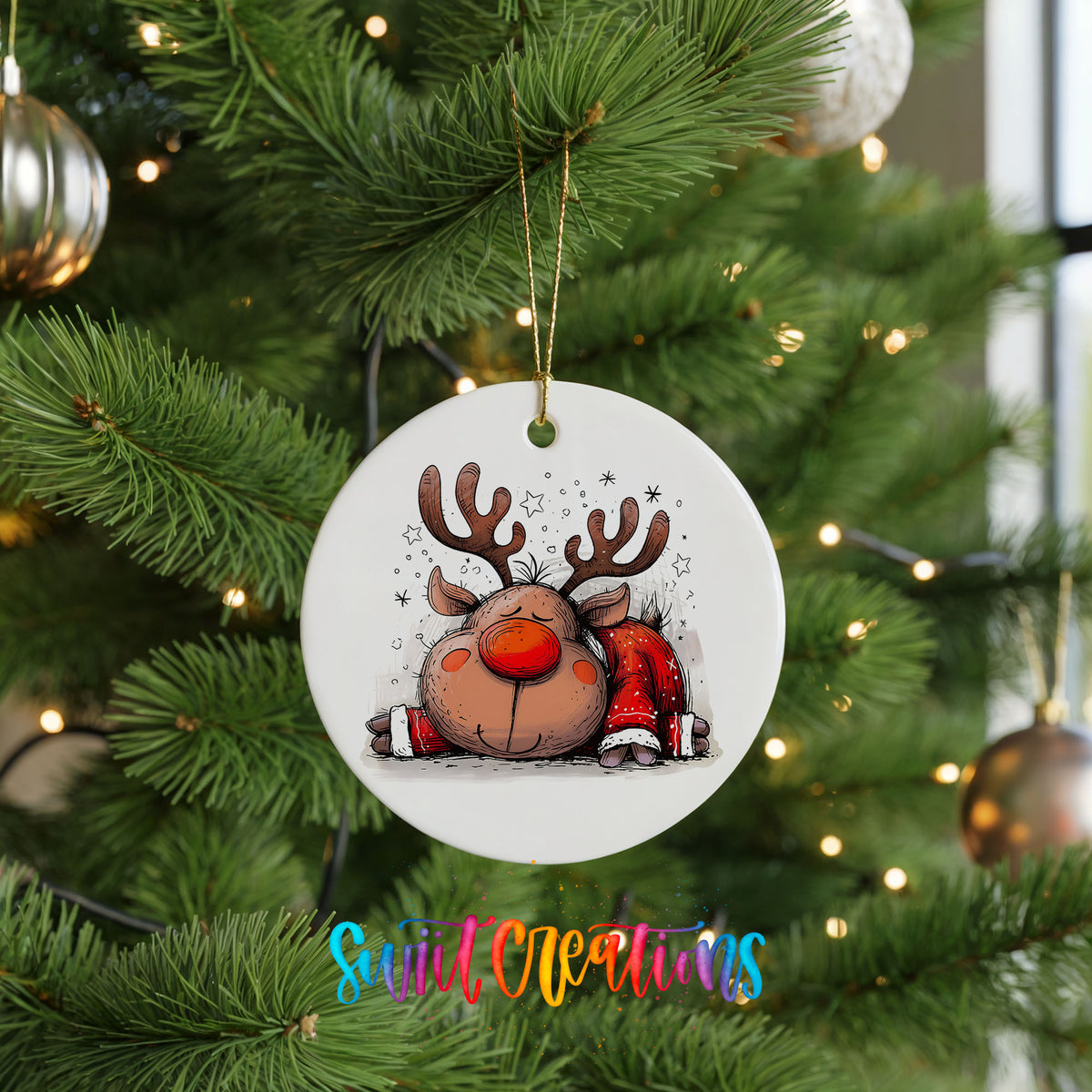 Sleeping Reindeer in Red Scarf Christmas ornament hanging on a green Christmas tree