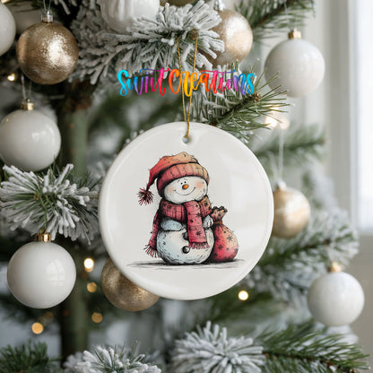 Snowman in Red Scarf with Gift Christmas ornament hanging on a frosted holiday tree