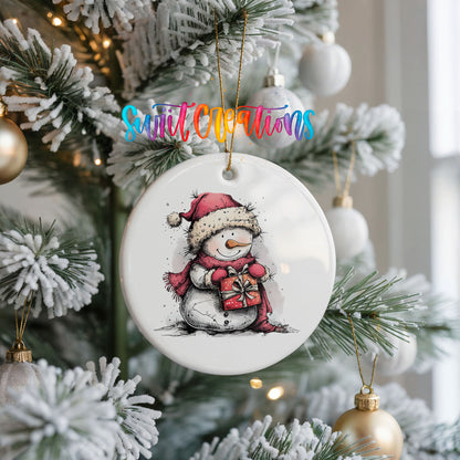 Snowman Holding a Christmas Heart Christmas ornament hanging on a frosted Christmas tree