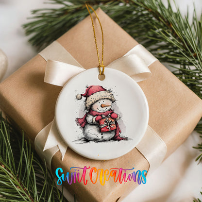 Snowman Holding a Christmas Heart Christmas ornament placed on a wrapped Christmas gift