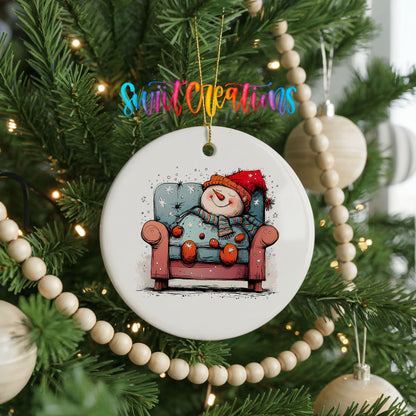 Santa Resting in a Holiday Armchair Christmas ornament hanging on a decorated Christmas tree