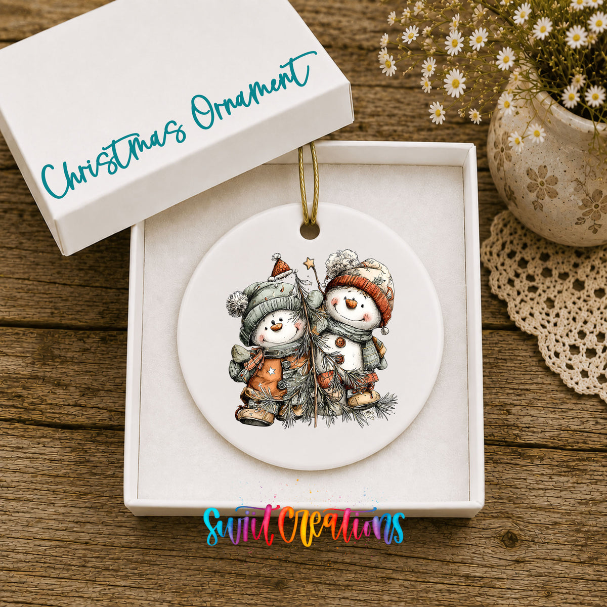 Snowman Pair in Orange and Gray Hats ceramic Christmas ornament displayed in gift box