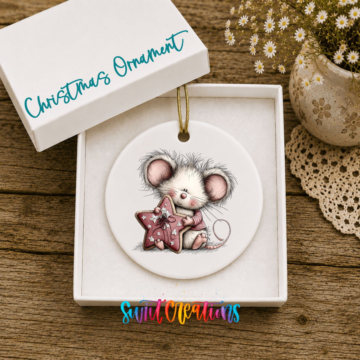 pink mouse holding a star ceramic Christmas ornament presented in a gift box
