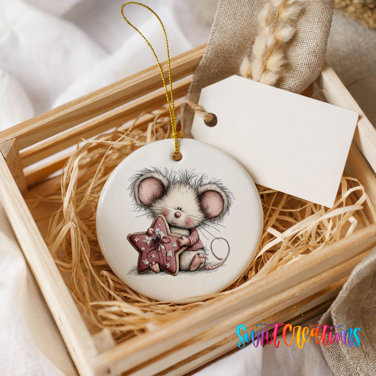 pink mouse holding a star ceramic Christmas ornament displayed in a wooden gift crate