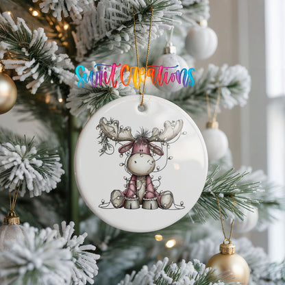 pink reindeer wrapped in Christmas lights ceramic Christmas ornament hanging on a frosted Christmas tree
