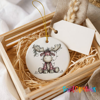pink reindeer wrapped in Christmas lights ceramic Christmas ornament displayed in a wooden gift crate