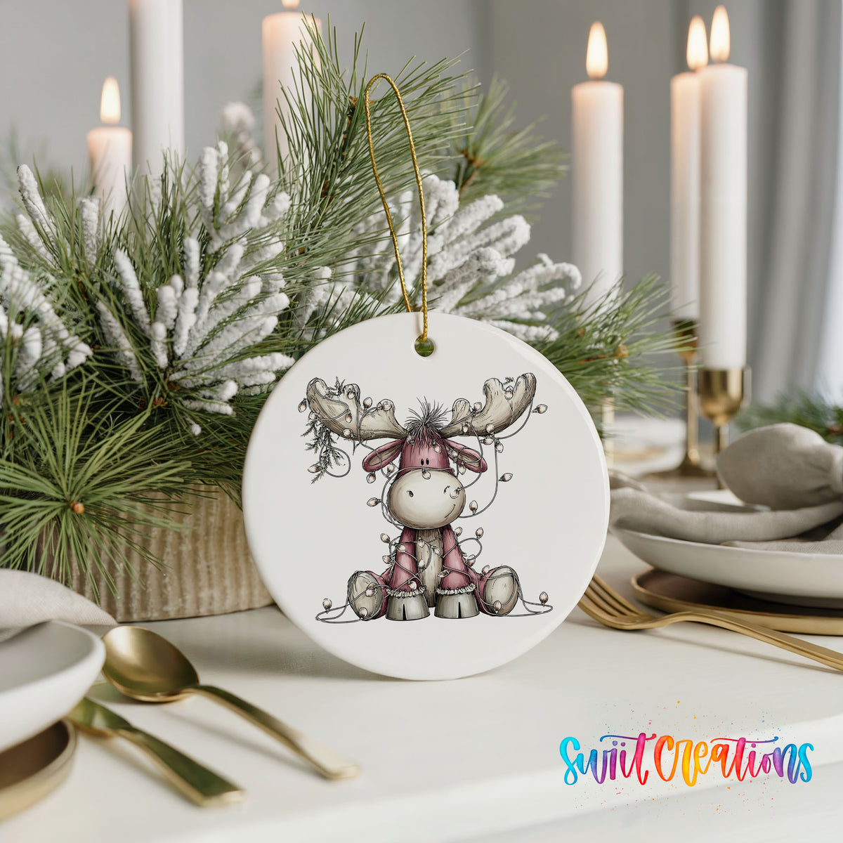 pink reindeer wrapped in Christmas lights ceramic Christmas ornament shown in a holiday table setting