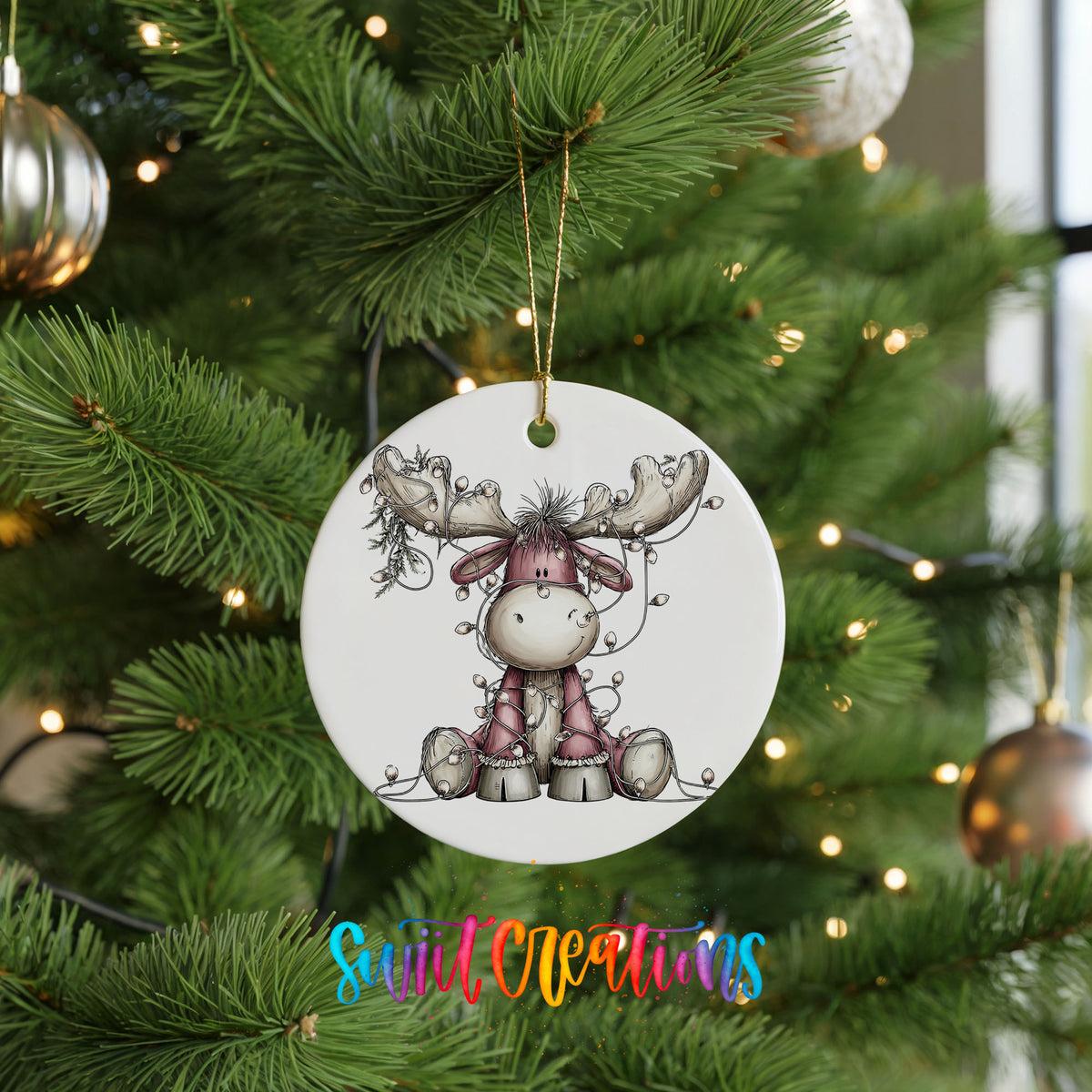 pink reindeer wrapped in Christmas lights ceramic Christmas ornament hanging on a lit Christmas tree