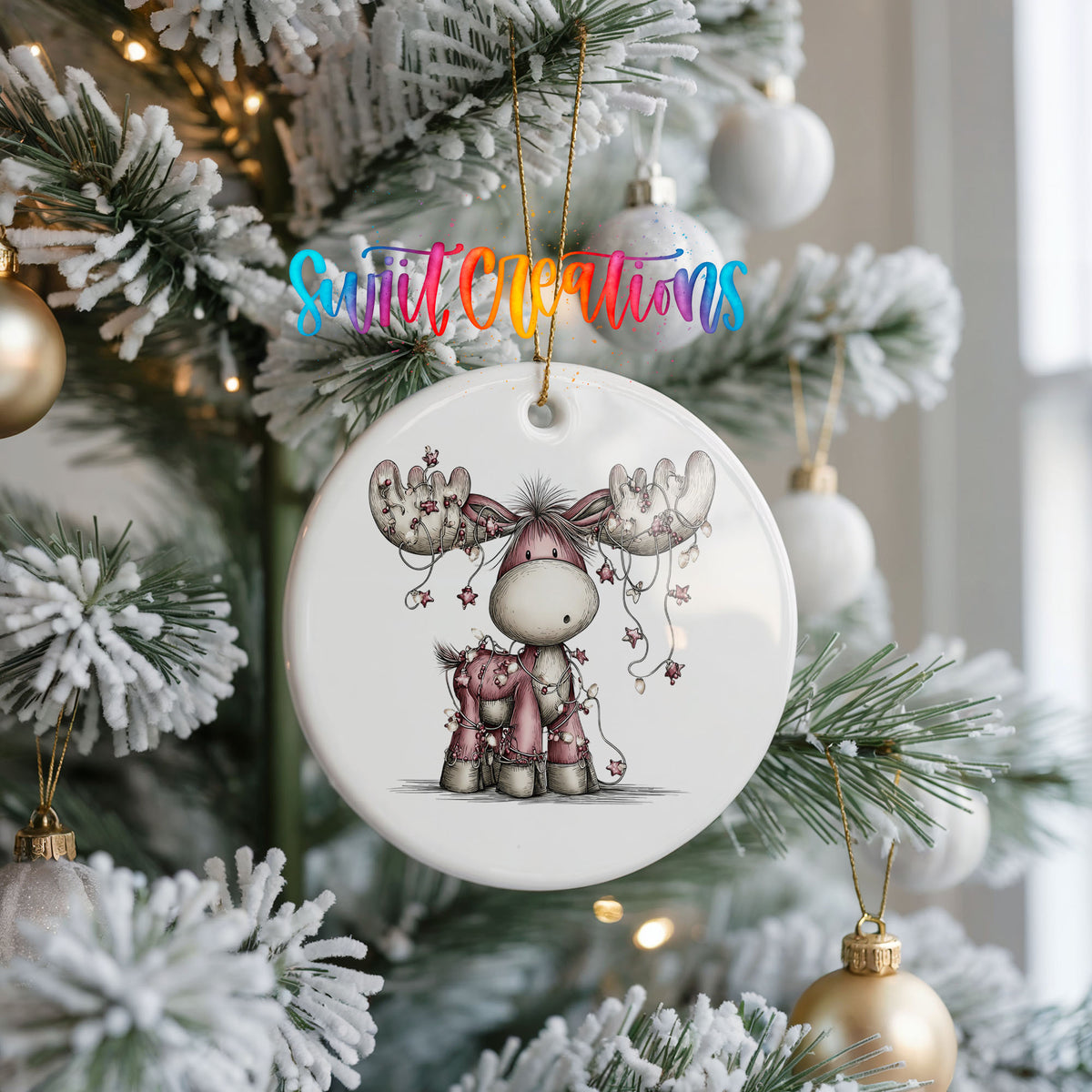 pink reindeer with hanging ornaments ceramic Christmas ornament hanging on a frosted Christmas tree