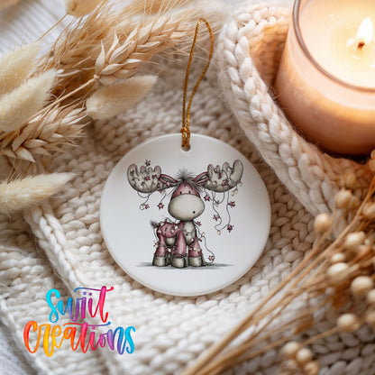 pink reindeer with hanging ornaments ceramic Christmas ornament styled on a cozy knit blanket