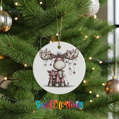 pink reindeer with hanging ornaments ceramic Christmas ornament hanging on a lit Christmas tree