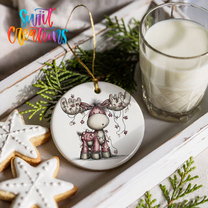 pink reindeer with hanging ornaments ceramic Christmas ornament styled with holiday cookies and a candle