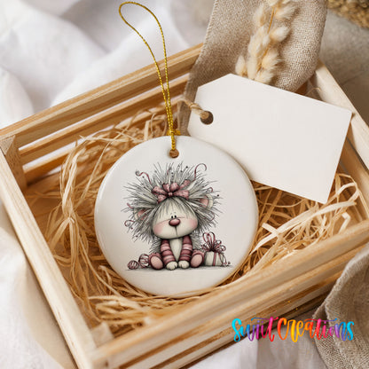 white and pink kitten in a floral winter headpiece ceramic Christmas ornament displayed in a wooden gift crate