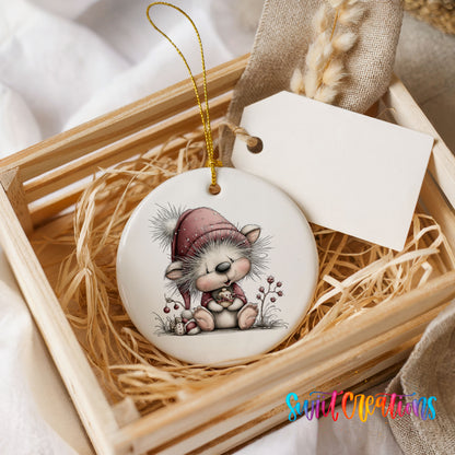 pink and gray kitten in a winter hat and scarf ceramic Christmas ornament displayed in a wooden gift crate