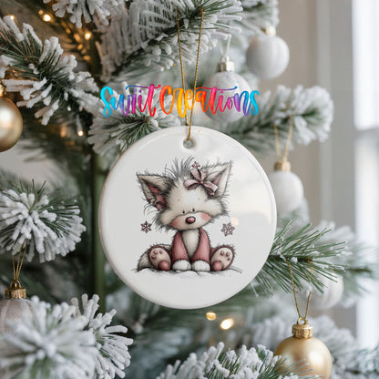 pink and gray kitten with snowflakes ceramic Christmas ornament hanging on a frosted Christmas tree