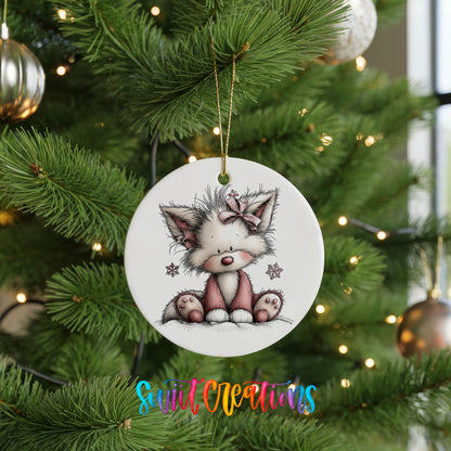 pink and gray kitten with snowflakes ceramic Christmas ornament hanging on a lit Christmas tree