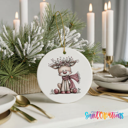pink reindeer in a scarf with a berry antler crown ceramic Christmas ornament shown in a holiday table setting
