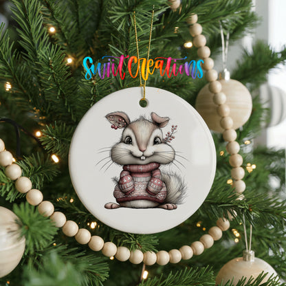 pink rabbit in a striped winter sweater ceramic Christmas ornament hanging on a green Christmas tree