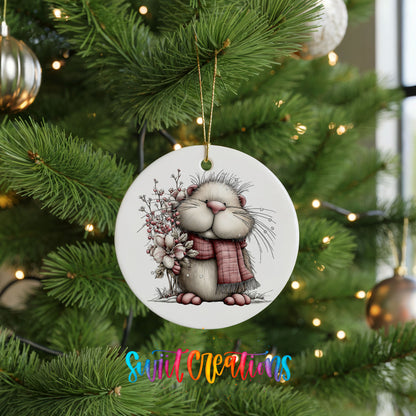 fluffy mouse in a pink scarf with flowers and berries ceramic Christmas ornament hanging on a lit Christmas tree