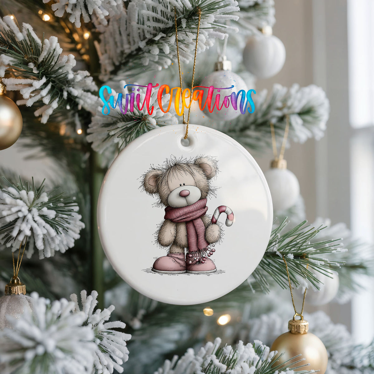 teddy bear in a pink scarf holding a candy cane ceramic Christmas ornament hanging on a frosted Christmas tree