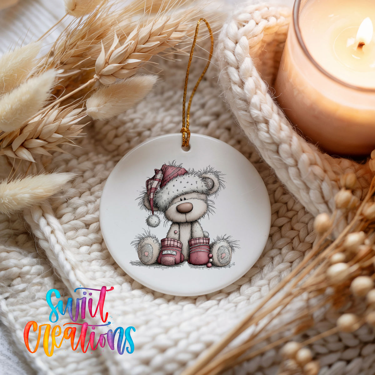 teddy bear in a Santa hat with Christmas gifts ceramic Christmas ornament styled on a cozy knit blanket