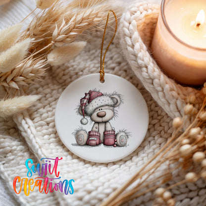 teddy bear in a Santa hat with Christmas gifts ceramic Christmas ornament styled on a cozy knit blanket
