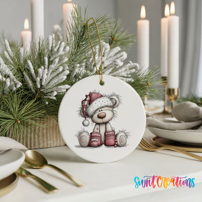 teddy bear in a Santa hat with Christmas gifts ceramic Christmas ornament shown in a holiday table setting