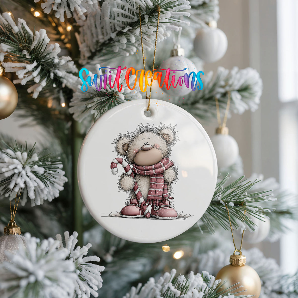 teddy bear holding a candy cane in winter clothes ceramic Christmas ornament hanging on a frosted Christmas tree