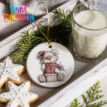 teddy bear sitting on a wrapped Christmas gift ceramic Christmas ornament styled with holiday cookies and a candle