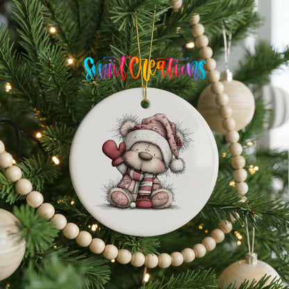 teddy bear holding a pink heart in a Santa hat ceramic Christmas ornament hanging on a green Christmas tree