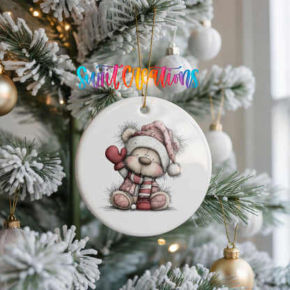 teddy bear holding a pink heart in a Santa hat ceramic Christmas ornament hanging on a frosted Christmas tree