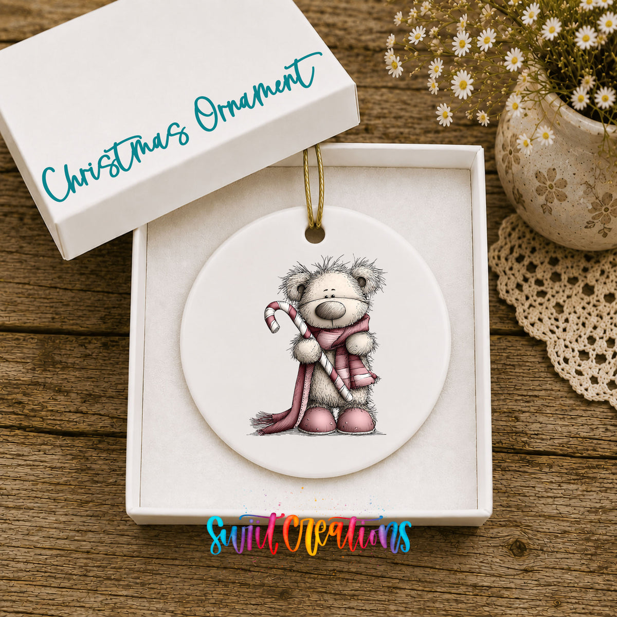 teddy bear holding a candy cane with a long winter scarf ceramic Christmas ornament presented in a gift box