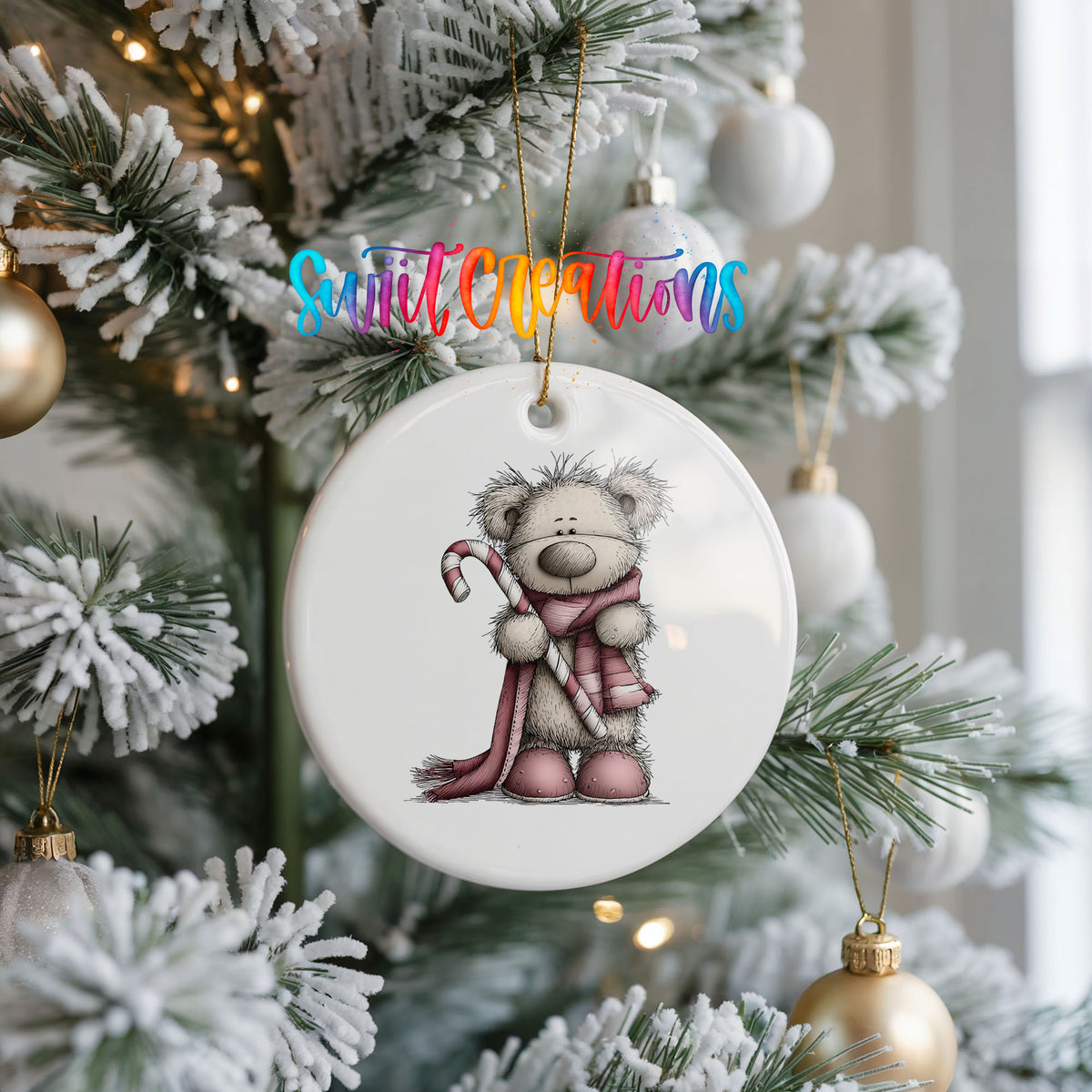 teddy bear holding a candy cane with a long winter scarf ceramic Christmas ornament hanging on a frosted Christmas tree