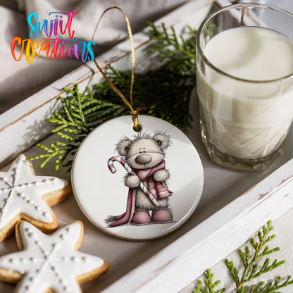 teddy bear holding a candy cane with a long winter scarf ceramic Christmas ornament styled with holiday cookies and a candle