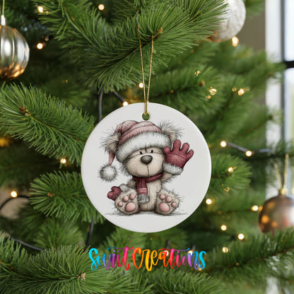 teddy bear waving beside Christmas gifts ceramic Christmas ornament hanging on a lit Christmas tree