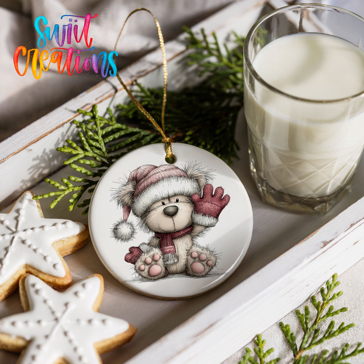 teddy bear waving beside Christmas gifts ceramic Christmas ornament styled with holiday cookies and a candle