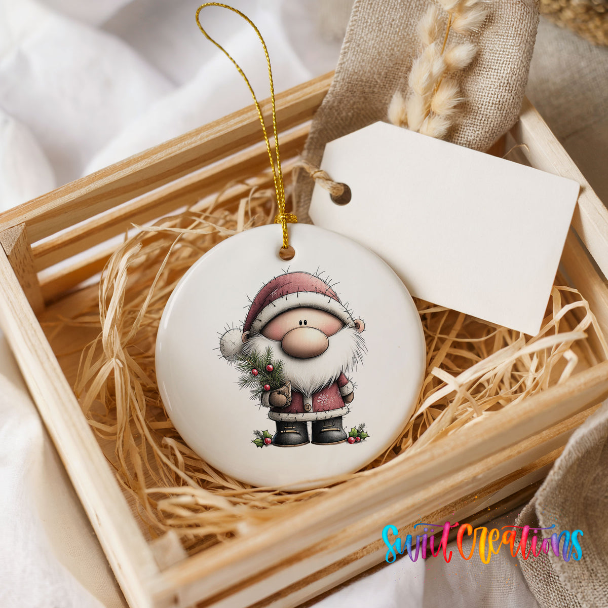 Santa Claus in a pink winter suit ceramic Christmas ornament displayed in a wooden gift crate
