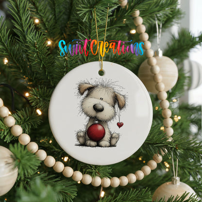fluffy Christmas puppy holding a red ornament ceramic Christmas ornament hanging on a green Christmas tree